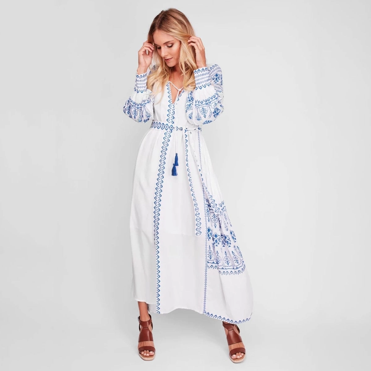Bahia Maxi Dress White With Blue Embroidery Long Puffed Peasant Sleeves Embroidered Pockets Bohemian Tassel Ties Available In Small Medium Large Or XL Tropical Wrap Maxi Dress